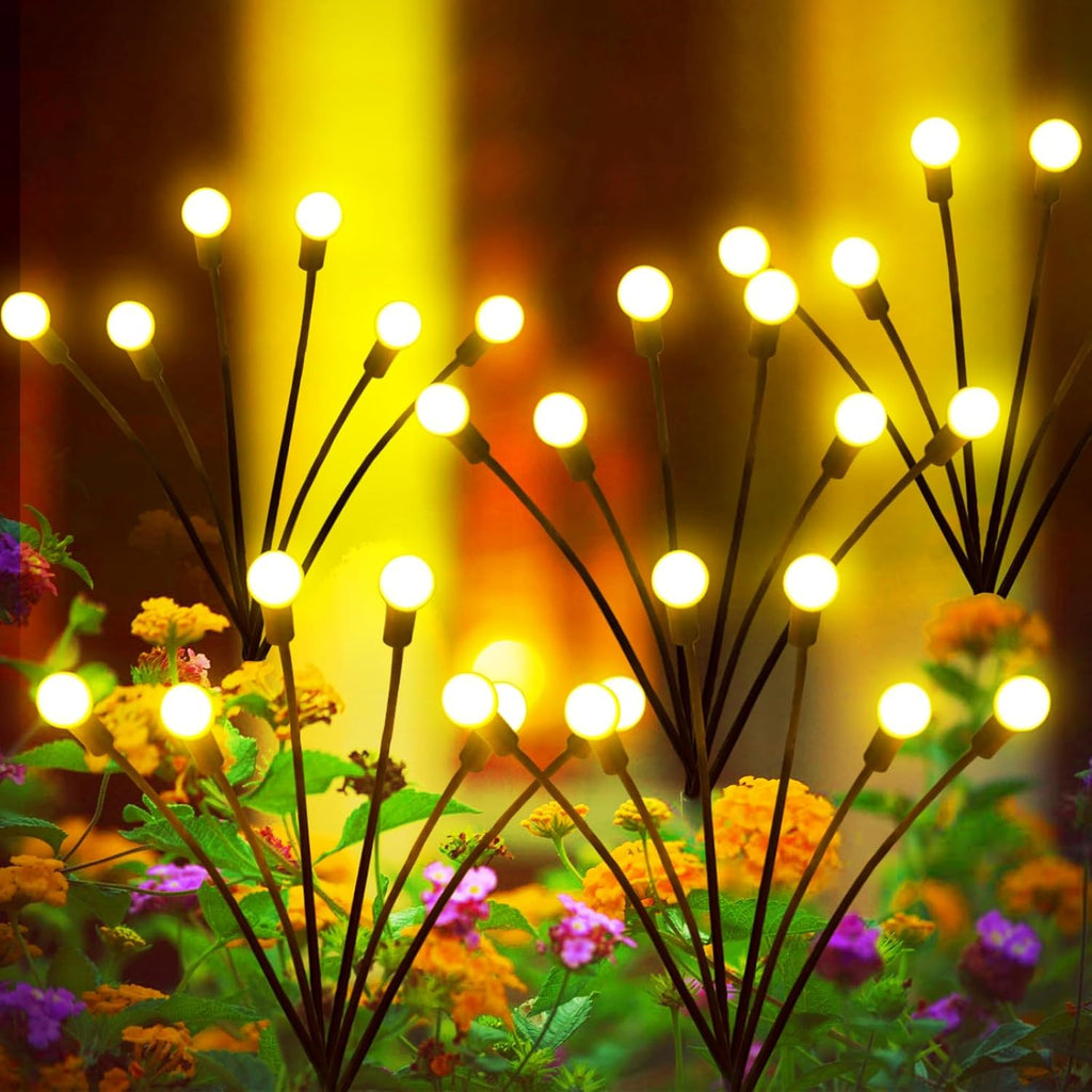 Warm white solar firefly lights swaying in an outdoor garden